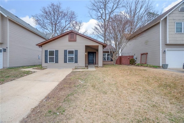 view of front of property with a garage, fence, and a front lawn