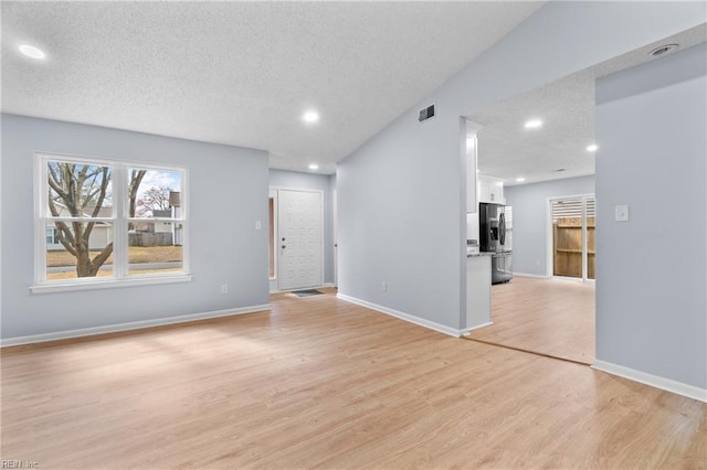 empty room featuring visible vents, baseboards, a textured ceiling, light wood-style floors, and recessed lighting