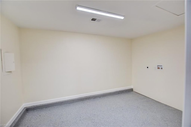 unfurnished room featuring visible vents, baseboards, and speckled floor