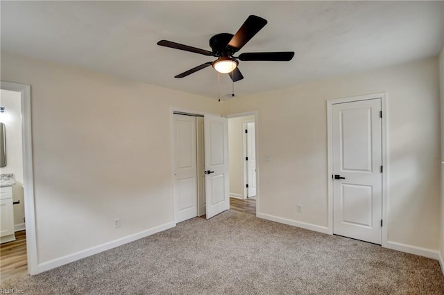 unfurnished bedroom with baseboards, a ceiling fan, and light colored carpet