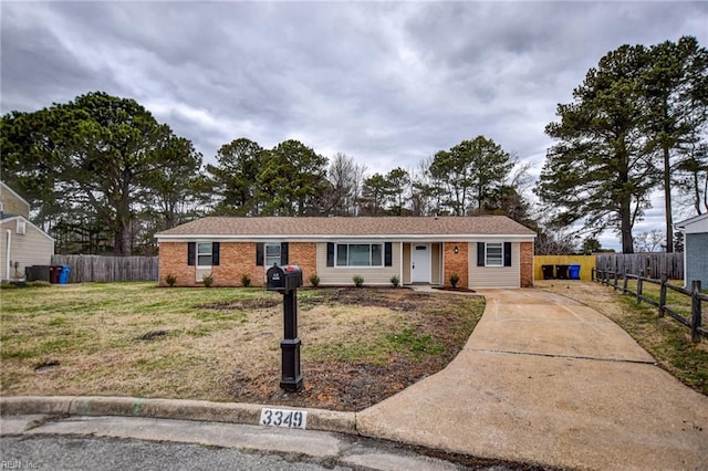 ranch-style house with brick siding, a front lawn, and fence