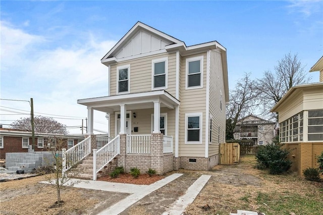 view of front facade featuring crawl space, fence, a porch, and board and batten siding