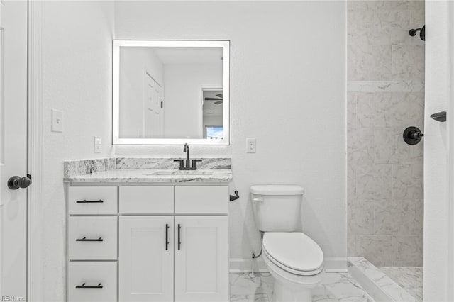 full bathroom featuring toilet, vanity, baseboards, marble finish floor, and a tile shower