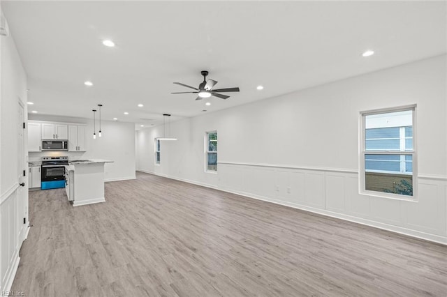 unfurnished living room featuring a ceiling fan, recessed lighting, and light wood finished floors