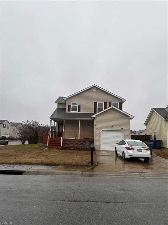 view of front of property with a porch, concrete driveway, fence, and a garage