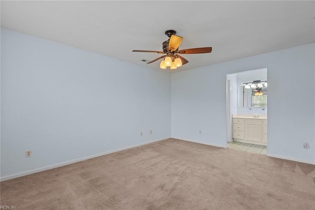 unfurnished room with light carpet, a ceiling fan, and baseboards