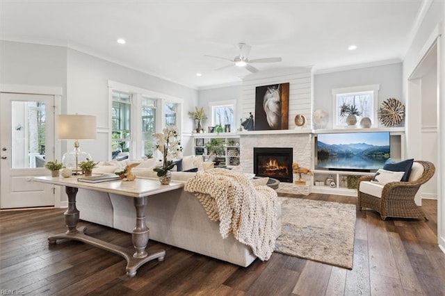 living room featuring crown molding, dark wood-style flooring, and a wealth of natural light