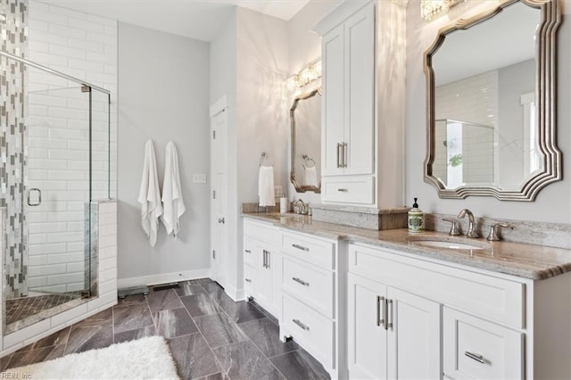 bathroom with double vanity, a sink, and a shower stall