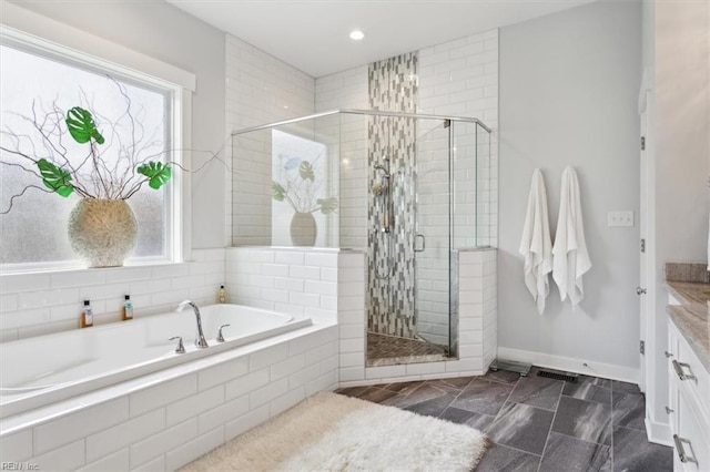 full bathroom with a garden tub, recessed lighting, vanity, baseboards, and a stall shower