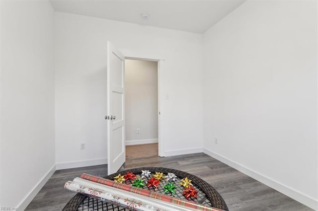 bedroom featuring baseboards and wood finished floors