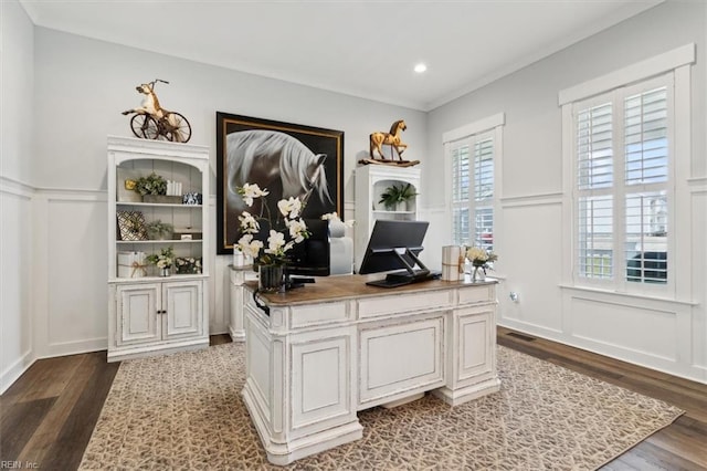 office space featuring ornamental molding, a decorative wall, and dark wood-style flooring