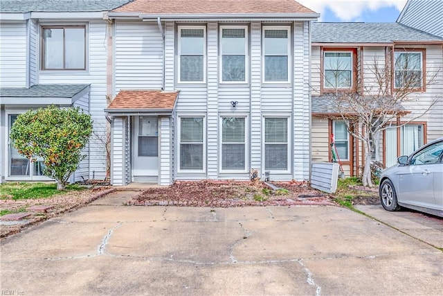 multi unit property featuring a shingled roof