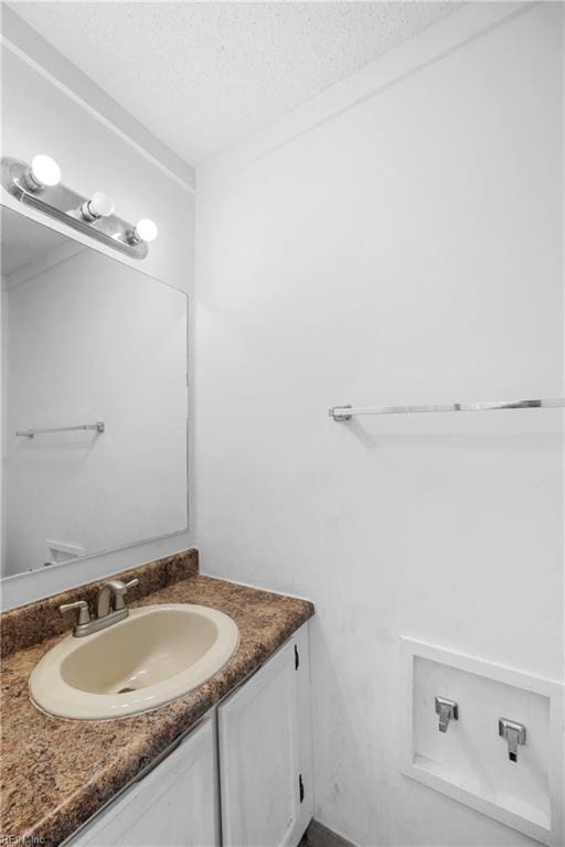 bathroom featuring a textured ceiling and vanity