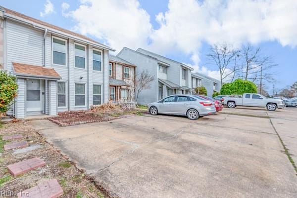 uncovered parking lot featuring a residential view