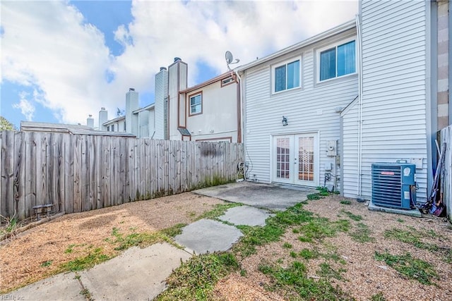 back of property featuring central air condition unit, a patio area, a fenced backyard, and french doors