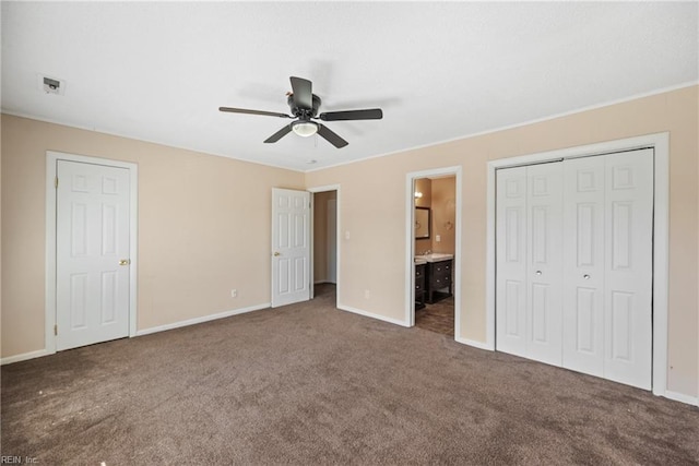 unfurnished bedroom with carpet floors, connected bathroom, a ceiling fan, and baseboards