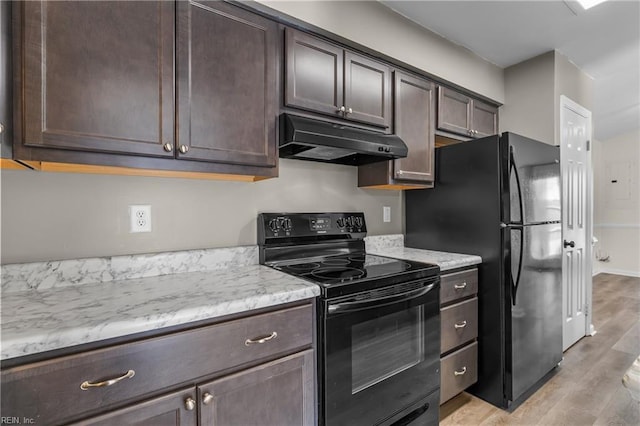 kitchen with light wood-style floors, dark brown cabinets, under cabinet range hood, and black appliances