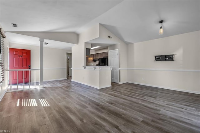 unfurnished living room with baseboards, visible vents, vaulted ceiling, and dark wood finished floors