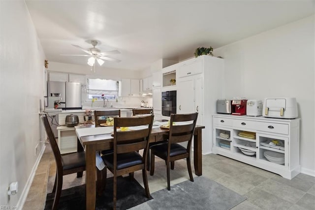 dining area featuring a ceiling fan and baseboards