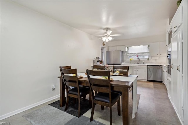 dining space featuring baseboards and ceiling fan