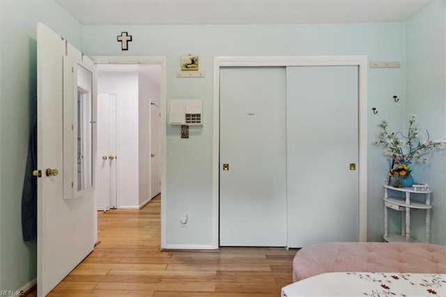 bedroom featuring a closet and light wood-style flooring