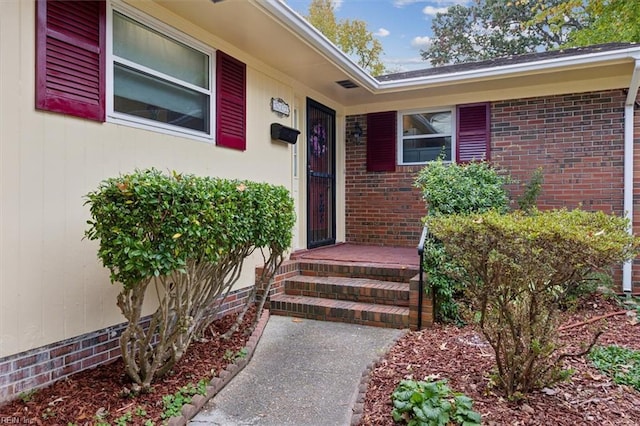 property entrance featuring brick siding