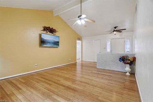 unfurnished living room featuring a ceiling fan, baseboards, high vaulted ceiling, beamed ceiling, and light wood-type flooring