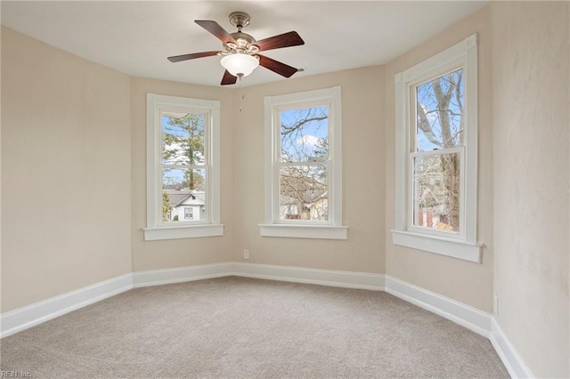 unfurnished room featuring carpet, baseboards, and a ceiling fan