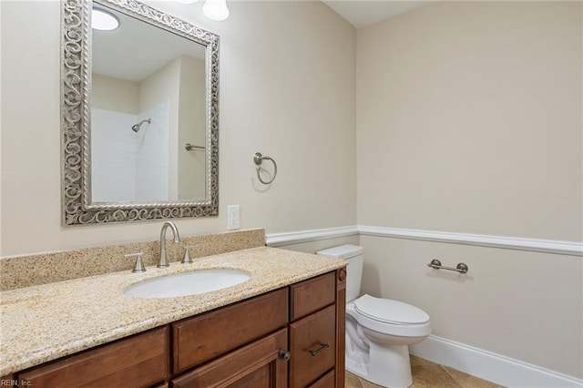 full bathroom featuring baseboards, toilet, tile patterned flooring, walk in shower, and vanity