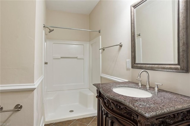 full bathroom featuring tile patterned floors, vanity, and walk in shower