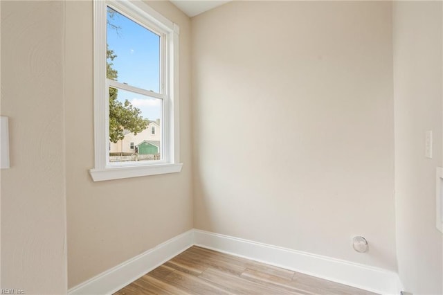 unfurnished room featuring baseboards and wood finished floors