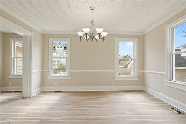 unfurnished dining area featuring light wood-type flooring, baseboards, and ornamental molding