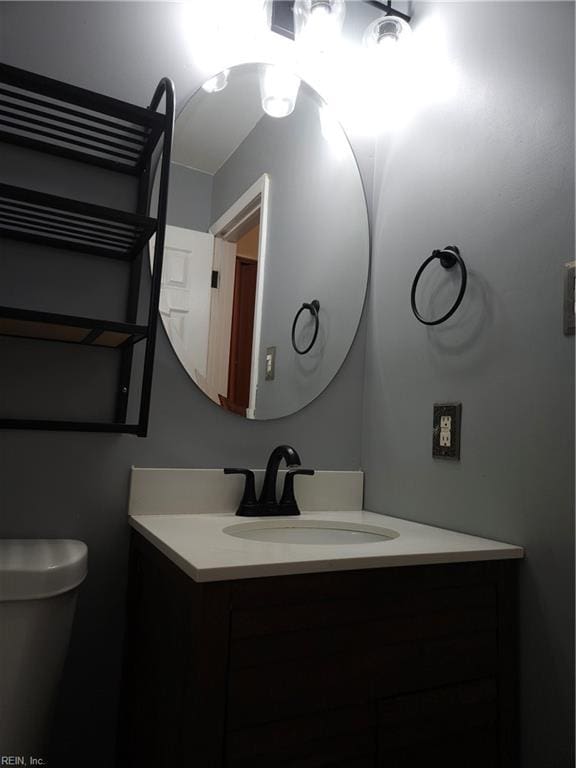 bathroom featuring toilet and vanity