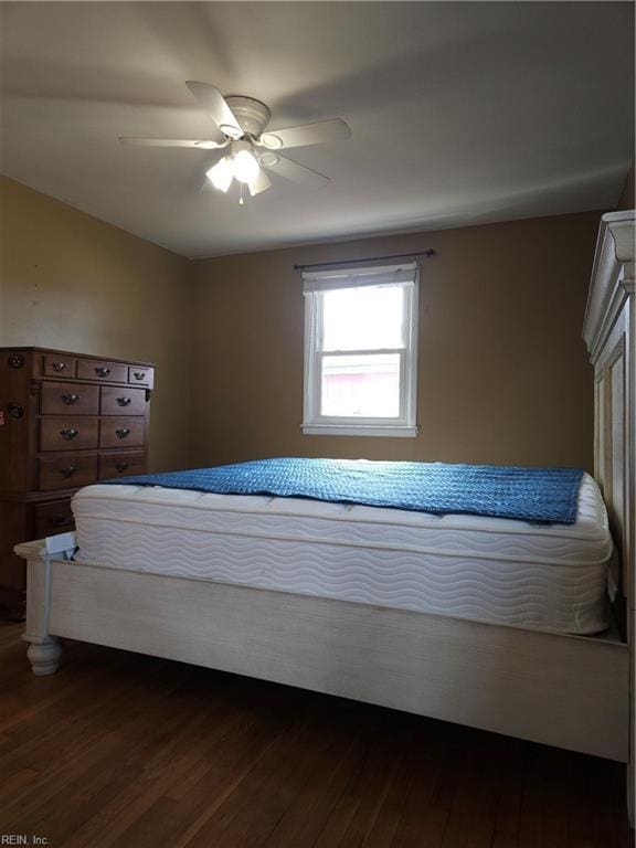 bedroom with dark wood-type flooring and a ceiling fan