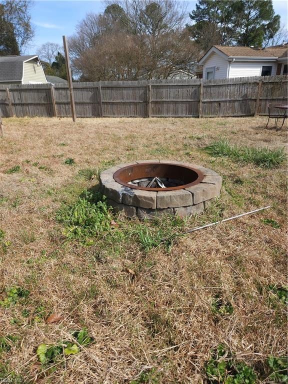 view of yard with an outdoor fire pit and a fenced backyard