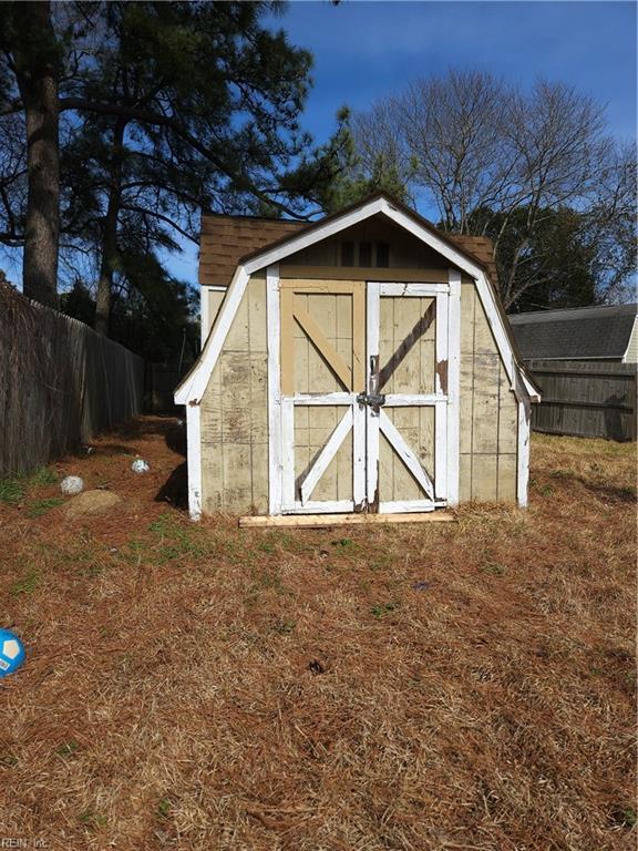 view of shed featuring fence