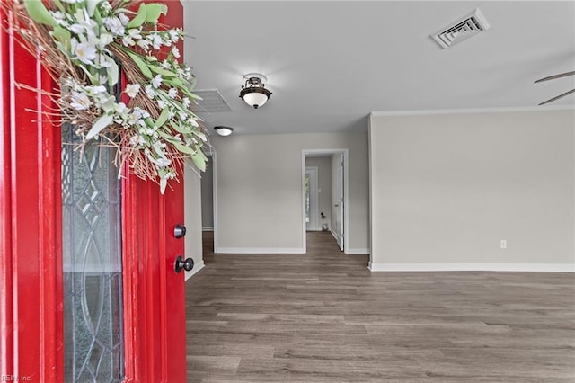 interior space with wood finished floors, visible vents, and baseboards