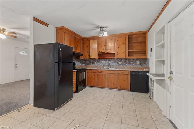 kitchen featuring black appliances, open shelves, under cabinet range hood, a sink, and tasteful backsplash