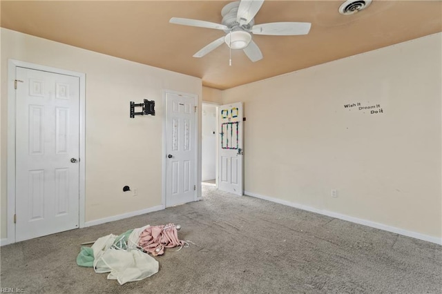 unfurnished bedroom featuring visible vents, carpet floors, baseboards, and ceiling fan