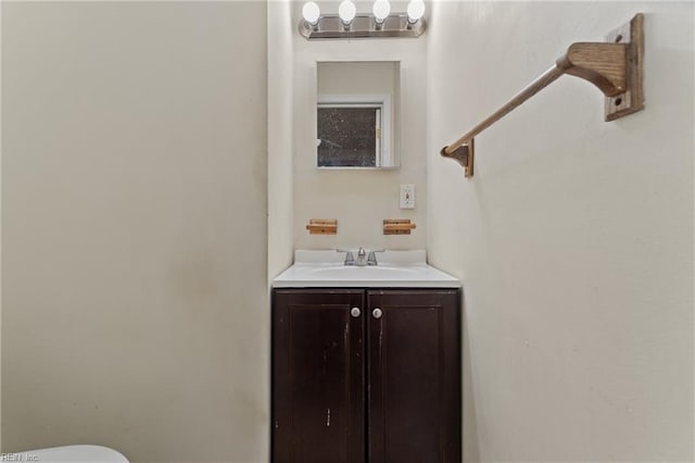 half bathroom with toilet and vanity