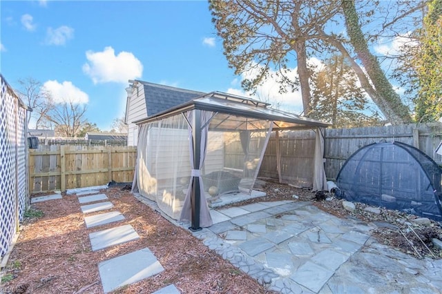 view of yard with a gazebo, a patio area, and a fenced backyard