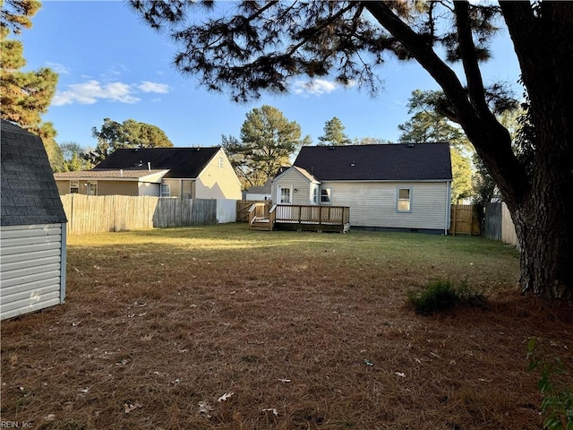 view of yard with a fenced backyard and a wooden deck