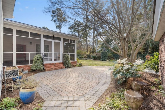 view of patio with a sunroom