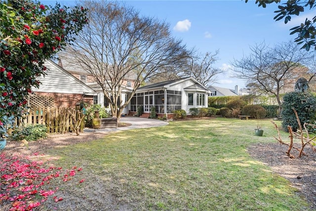 view of yard featuring a patio area and a sunroom