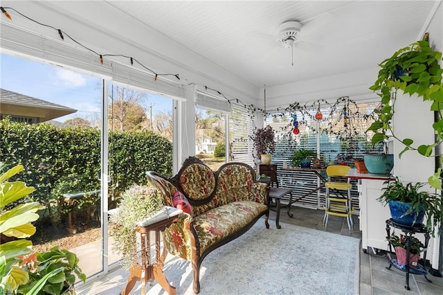 sunroom / solarium with a ceiling fan