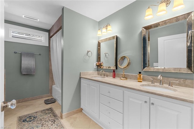 bathroom with a sink, visible vents, double vanity, and tile patterned flooring