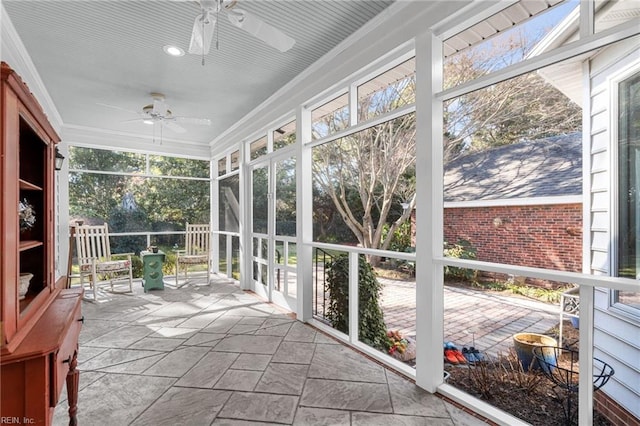 sunroom / solarium featuring ceiling fan