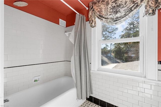 full bathroom featuring a healthy amount of sunlight and shower / bath combination with curtain