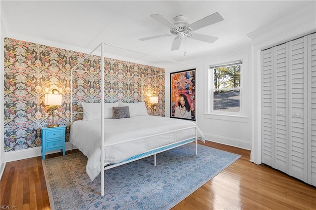 unfurnished bedroom featuring baseboards, wood finished floors, and crown molding