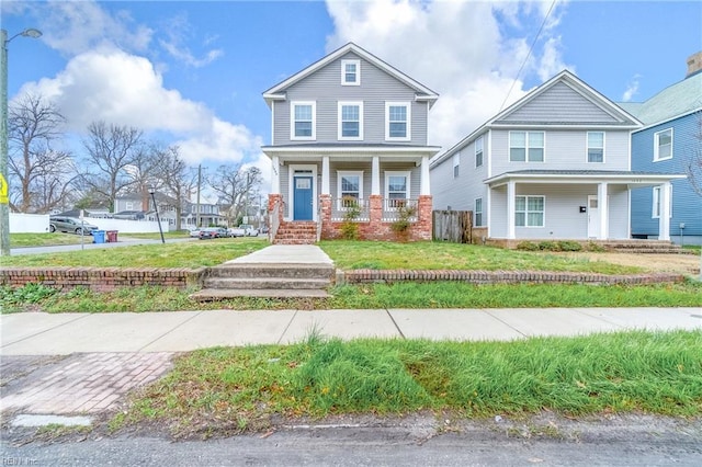 view of front of house with a front lawn, a porch, and brick siding